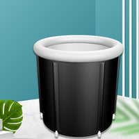 Black inflatable bathtub with white rim on a blue background